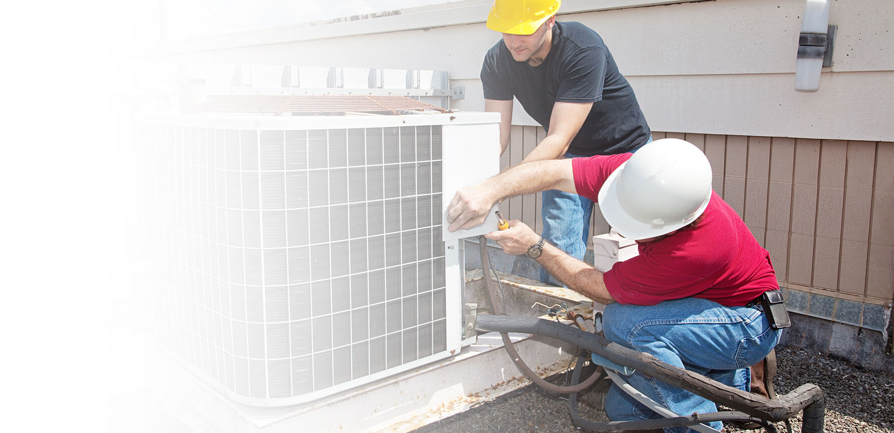 men working on AC unit